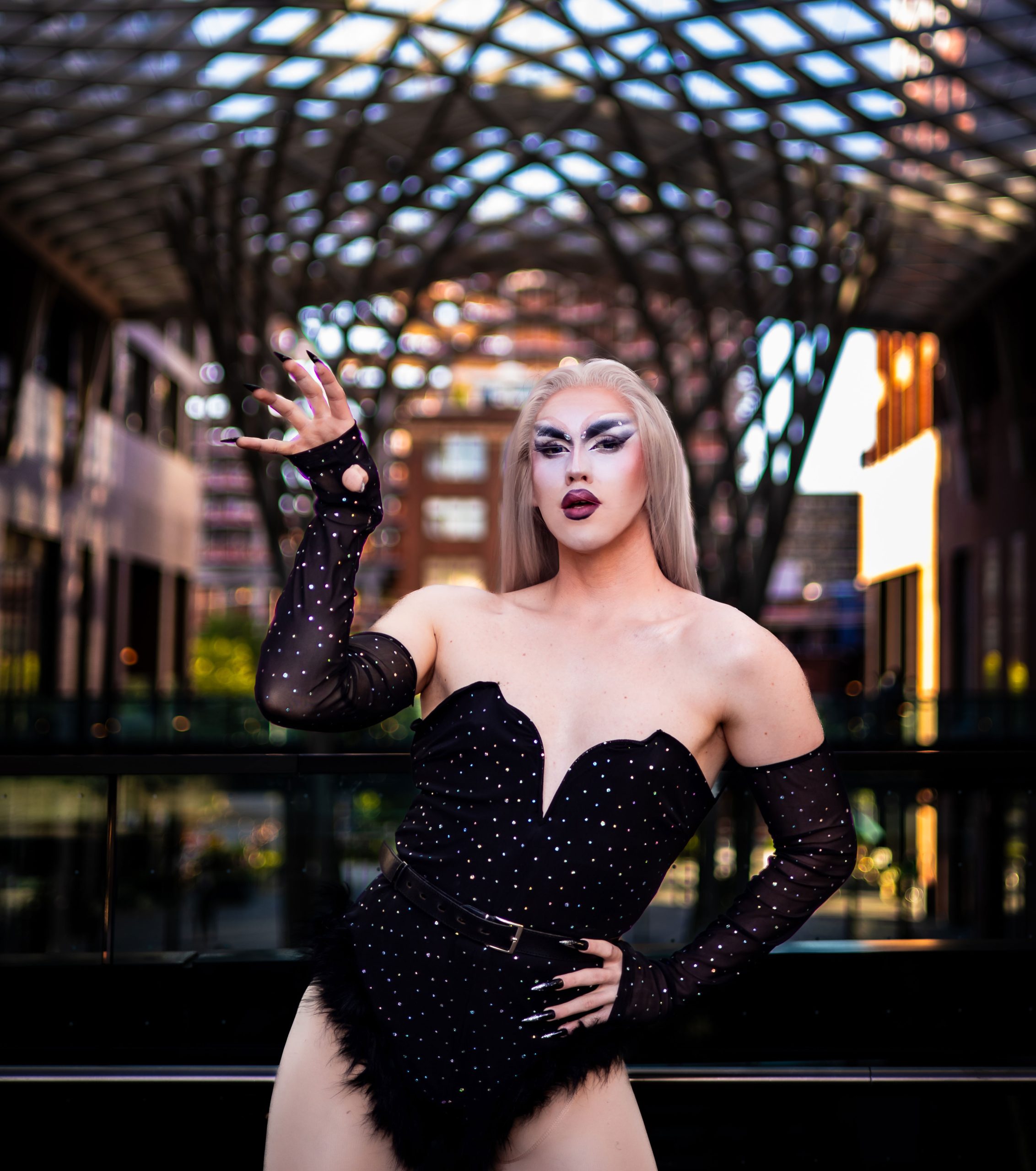 Callie Croken, a life and business coach, sipping coffee playfully in a window sill during her branding photoshoot with Lake Design.